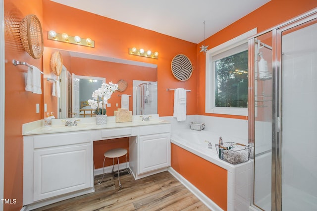 302 Caraway Ln, Cary, NC 27519 - full bathroom with a stall shower, double vanity, a garden tub, and wood finished floors