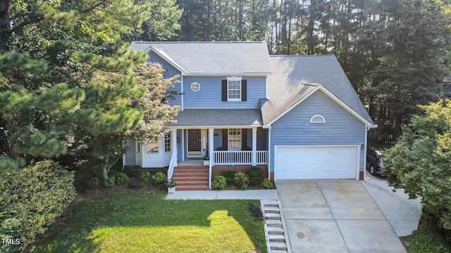 302 Caraway Ln, Cary, NC 27519 - view of front facade with covered porch, concrete driveway, an attached garage, roof with shingles, and a front yard