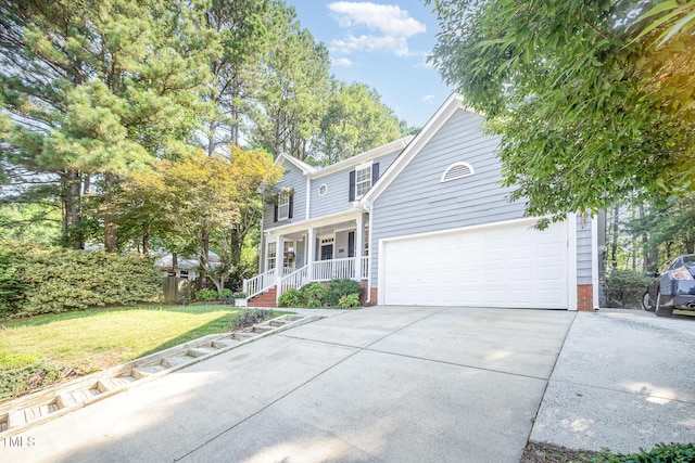 302 Caraway Ln, Cary, NC 27519 - traditional-style house with covered porch, driveway, brick siding, a front yard, and a garage