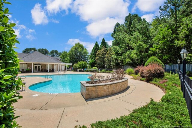 612 Marshtree Ln Unit 304, Fayetteville, NC 28314 - community pool with a patio area and view of wooded area