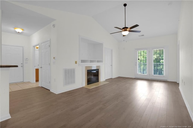 612 Marshtree Ln Unit 304, Fayetteville, NC 28314 - unfurnished living room with a ceiling fan, wood finished floors, a glass covered fireplace, and lofted ceiling