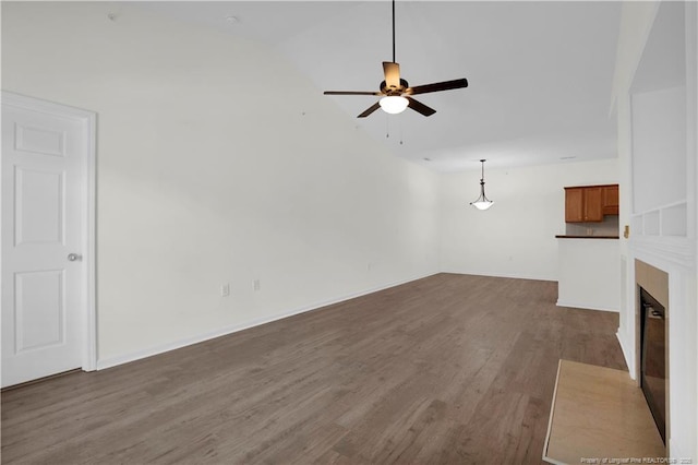 612 Marshtree Ln Unit 304, Fayetteville, NC 28314 - unfurnished living room with dark wood-style floors, a ceiling fan, a fireplace with flush hearth, and vaulted ceiling