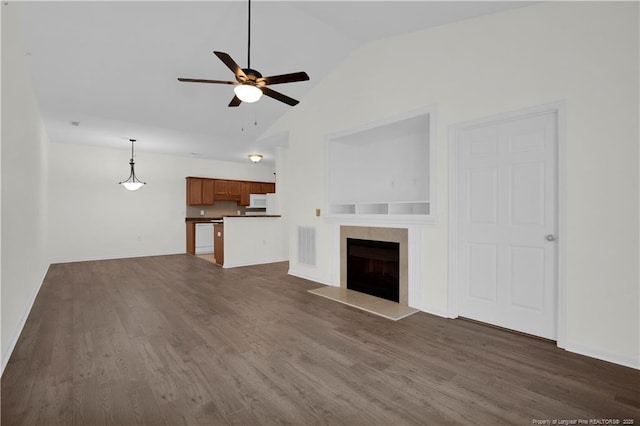 612 Marshtree Ln Unit 304, Fayetteville, NC 28314 - unfurnished living room featuring a ceiling fan, vaulted ceiling, dark wood-style flooring, and a fireplace
