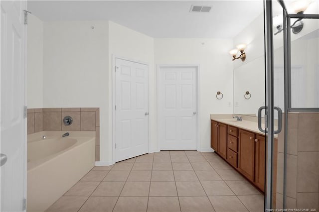 612 Marshtree Ln Unit 304, Fayetteville, NC 28314 - full bath featuring tile patterned floors, vanity, a garden tub, and a shower with door