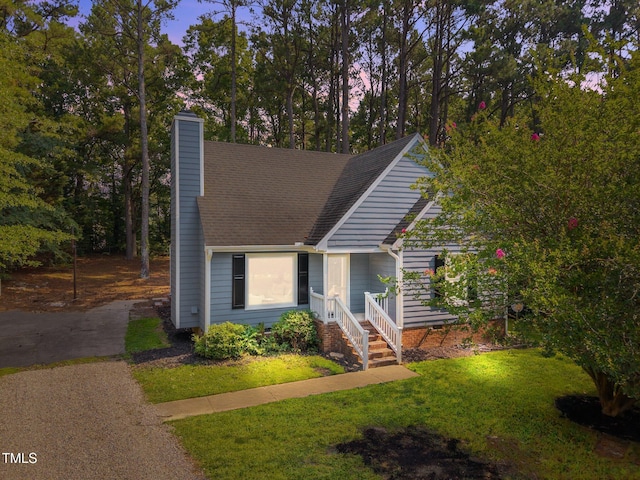 5721 Meadow Run, Knightdale, NC 27545 - view of front of house with a chimney, a front lawn, and a shingled roof