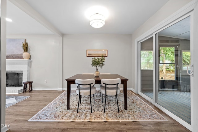5721 Meadow Run, Knightdale, NC 27545 - dining area featuring wood finished floors and a brick fireplace