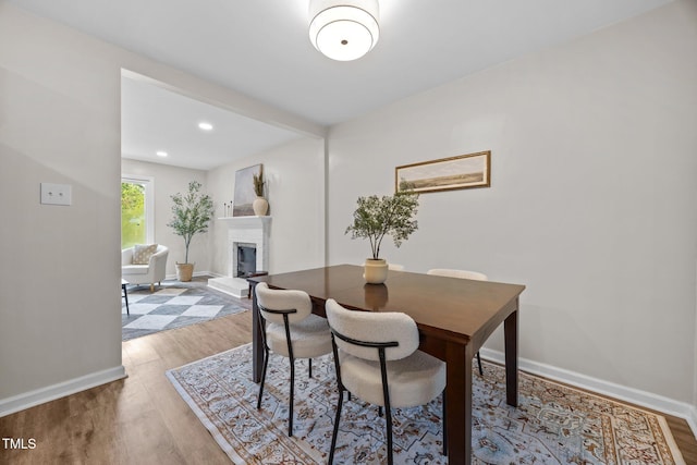 5721 Meadow Run, Knightdale, NC 27545 - dining room with light wood-type flooring, a fireplace, and recessed lighting