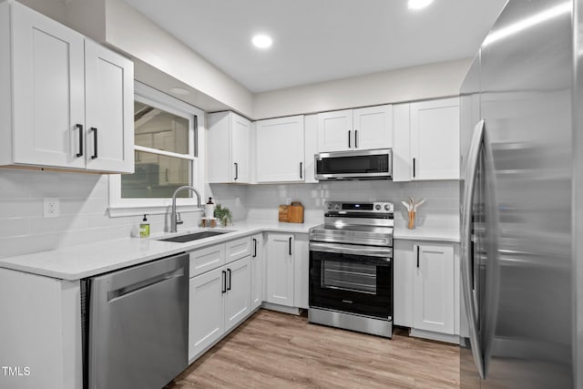 5721 Meadow Run, Knightdale, NC 27545 - kitchen featuring stainless steel appliances, white cabinets, light countertops, tasteful backsplash, and recessed lighting