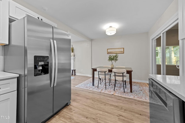 5721 Meadow Run, Knightdale, NC 27545 - kitchen featuring stainless steel refrigerator with ice dispenser, light wood finished floors, white cabinets, and light stone countertops