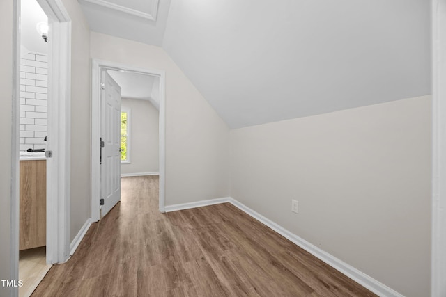5721 Meadow Run, Knightdale, NC 27545 - additional living space featuring wood finished floors and vaulted ceiling