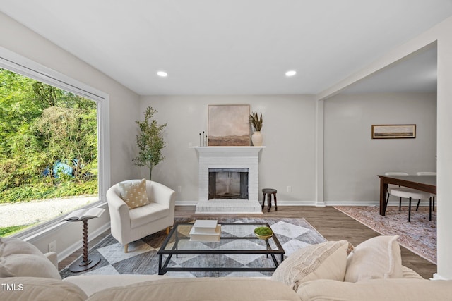 5721 Meadow Run, Knightdale, NC 27545 - living area featuring a fireplace, wood finished floors, and recessed lighting