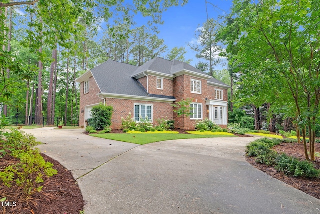 105 Bathgate Ln, Cary, NC 27513 - view of front facade featuring driveway, brick siding, an attached garage, and a shingled roof