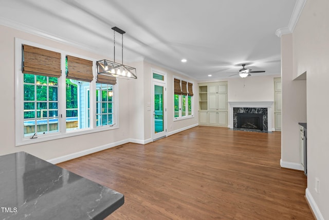 105 Bathgate Ln, Cary, NC 27513 - unfurnished living room featuring a ceiling fan, ornamental molding, a fireplace, wood finished floors, and recessed lighting