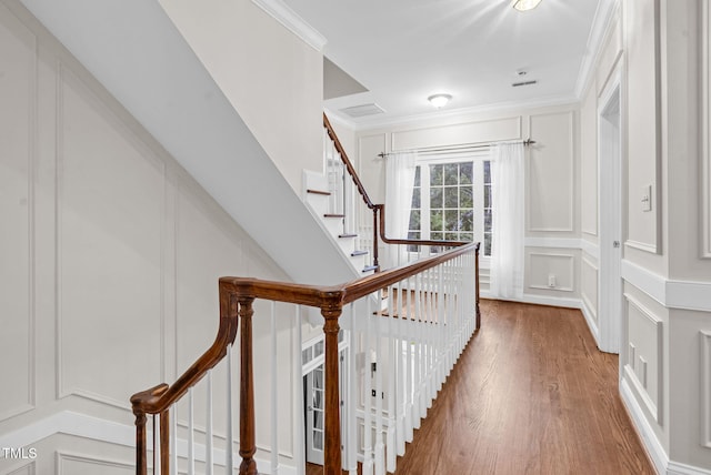 105 Bathgate Ln, Cary, NC 27513 - corridor with a decorative wall, wood finished floors, ornamental molding, and stairway