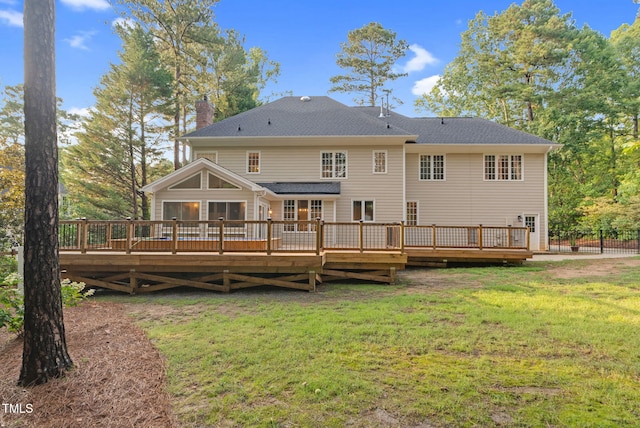 105 Bathgate Ln, Cary, NC 27513 - rear view of property with a chimney, a lawn, and a wooden deck