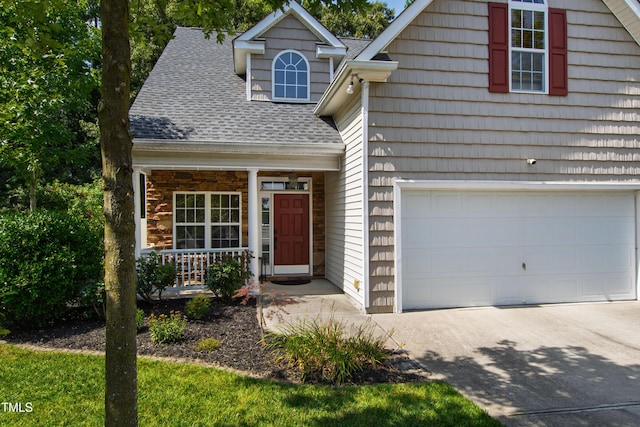 8205 Rolling Glenn Dr, Raleigh, NC 27616 - view of front facade featuring roof with shingles, a porch, driveway, and an attached garage
