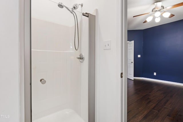 8205 Rolling Glenn Dr, Raleigh, NC 27616 - bathroom featuring a stall shower, wood finished floors, and a ceiling fan