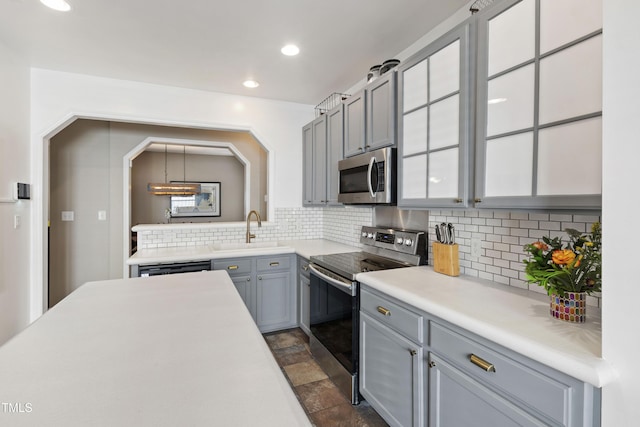 8205 Rolling Glenn Dr, Raleigh, NC 27616 - kitchen with stainless steel appliances, backsplash, light countertops, recessed lighting, and stone finish flooring