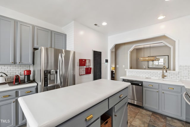 8205 Rolling Glenn Dr, Raleigh, NC 27616 - kitchen featuring stainless steel appliances, gray cabinetry, tasteful backsplash, and recessed lighting