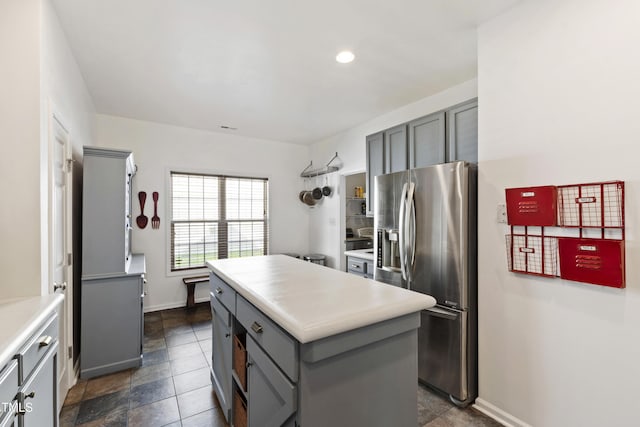 8205 Rolling Glenn Dr, Raleigh, NC 27616 - kitchen featuring stainless steel fridge with ice dispenser, gray cabinetry, a center island, light countertops, and recessed lighting