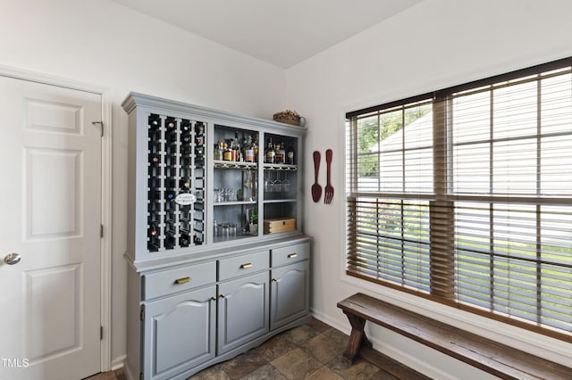 8205 Rolling Glenn Dr, Raleigh, NC 27616 - wine room featuring dark stone finish flooring and baseboards