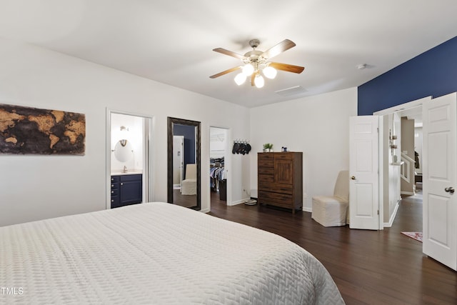 8205 Rolling Glenn Dr, Raleigh, NC 27616 - bedroom featuring dark wood finished floors, a walk in closet, connected bathroom, a closet, and ceiling fan
