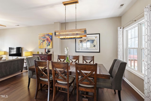 8205 Rolling Glenn Dr, Raleigh, NC 27616 - dining room featuring dark wood-style flooring and baseboards