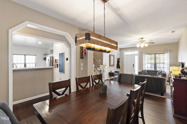8205 Rolling Glenn Dr, Raleigh, NC 27616 - dining room with stairs, dark wood finished floors, and a ceiling fan