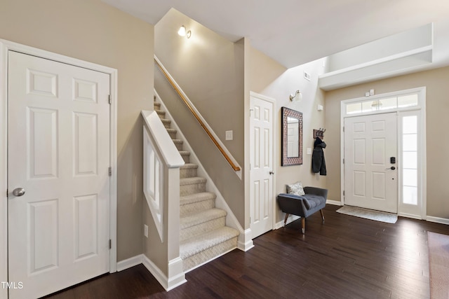 8205 Rolling Glenn Dr, Raleigh, NC 27616 - foyer entrance with dark wood-style floors and stairs