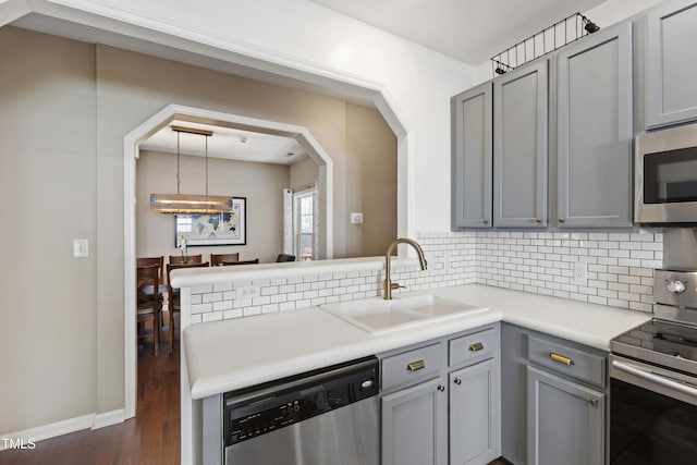 8205 Rolling Glenn Dr, Raleigh, NC 27616 - kitchen with appliances with stainless steel finishes, gray cabinetry, and tasteful backsplash
