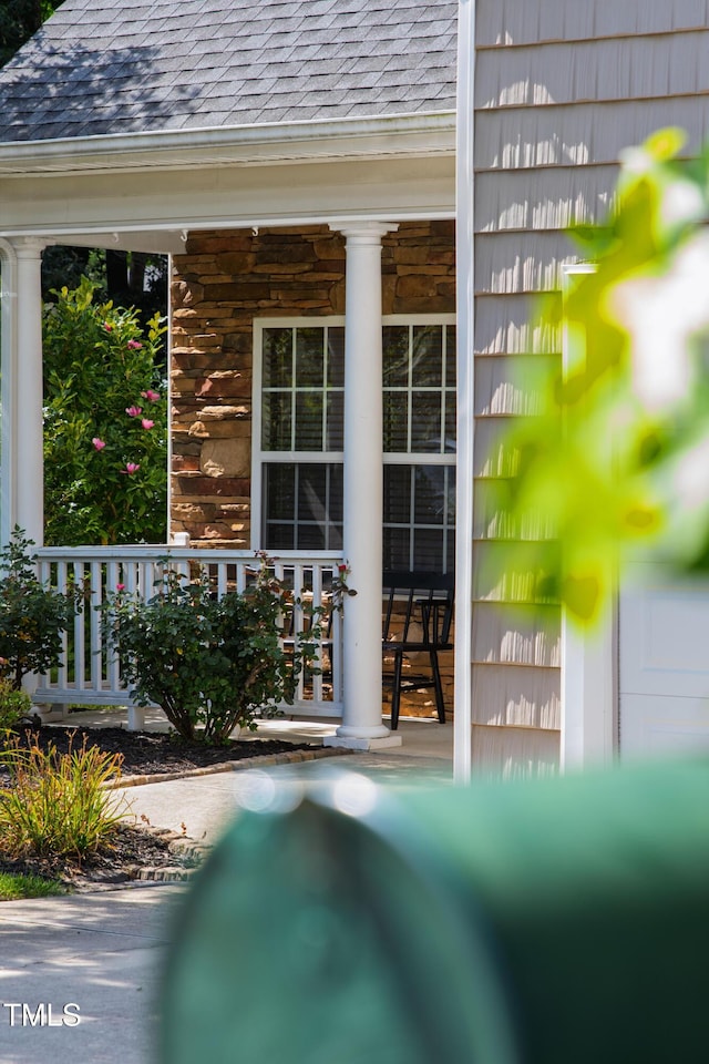 8205 Rolling Glenn Dr, Raleigh, NC 27616 - exterior view of a shingled roof, a downspout, ornate columns, and gutters