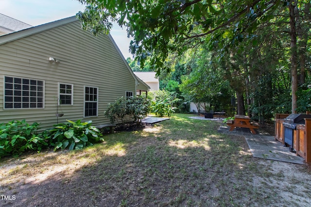 8205 Rolling Glenn Dr, Raleigh, NC 27616 - view of grassy yard with an outdoor fire pit and a patio