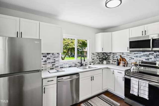 208 Fairview Ave SW, Wilson, NC 27893 - kitchen featuring stainless steel appliances, light countertops, backsplash, and white cabinetry
