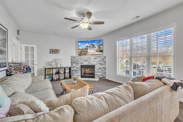 1968 Shadow Glen Dr, Raleigh, NC 27604 - carpeted living room featuring a ceiling fan, a fireplace, and a textured ceiling