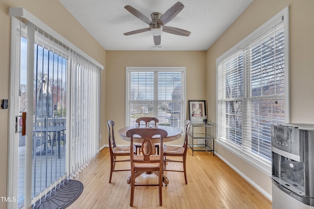 1968 Shadow Glen Dr, Raleigh, NC 27604 - dining space featuring light wood-style floors, a ceiling fan, and a textured ceiling