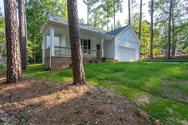 6069 Jones Cir, Sanford, NC 27332 - view of front of home featuring a porch, an attached garage, a front lawn, and board and batten siding