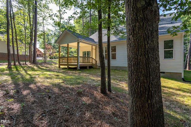 6069 Jones Cir, Sanford, NC 27332 - back of property with a deck, a lawn, and a shingled roof
