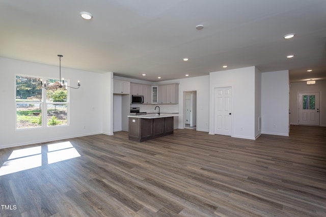 6069 Jones Cir, Sanford, NC 27332 - kitchen with open floor plan, stainless steel appliances, a chandelier, dark wood finished floors, and recessed lighting