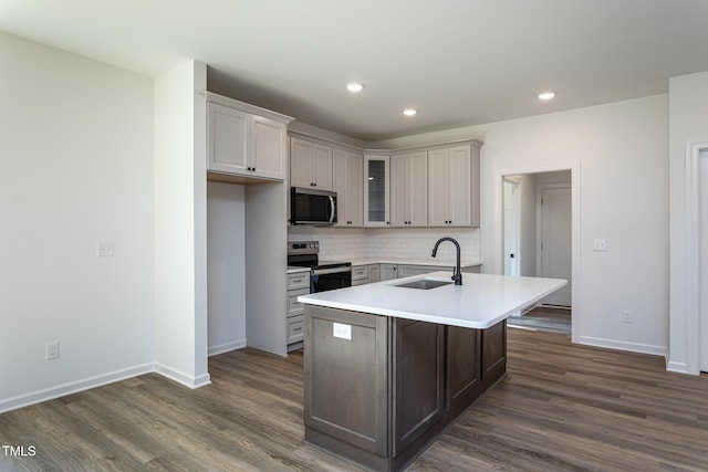 6069 Jones Cir, Sanford, NC 27332 - kitchen featuring appliances with stainless steel finishes, dark wood-style flooring, decorative backsplash, glass insert cabinets, and light countertops