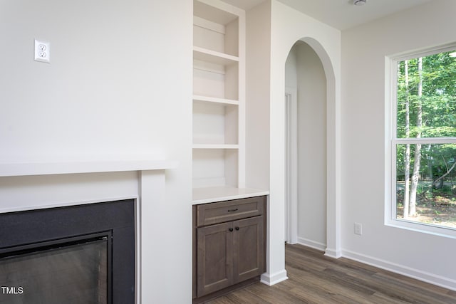 6069 Jones Cir, Sanford, NC 27332 - unfurnished living room with dark wood-type flooring and arched walkways