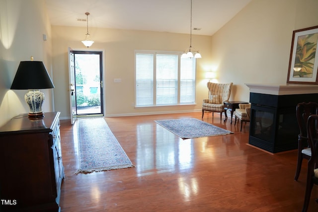 3423 Van Hessen Dr, Raleigh, NC 27614 - entryway with vaulted ceiling, wood finished floors, a chandelier, and a multi sided fireplace