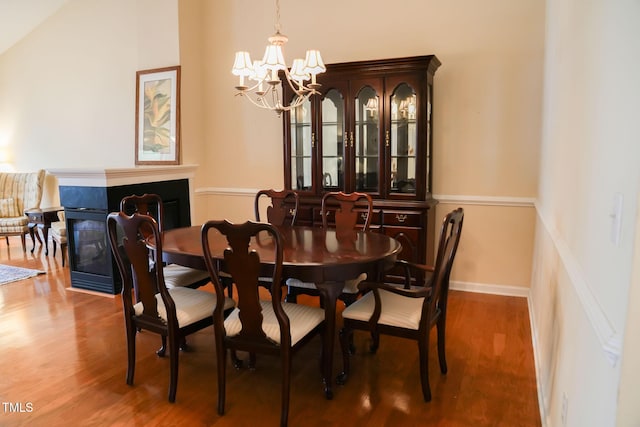 3423 Van Hessen Dr, Raleigh, NC 27614 - dining space with a chandelier, a fireplace, and wood finished floors