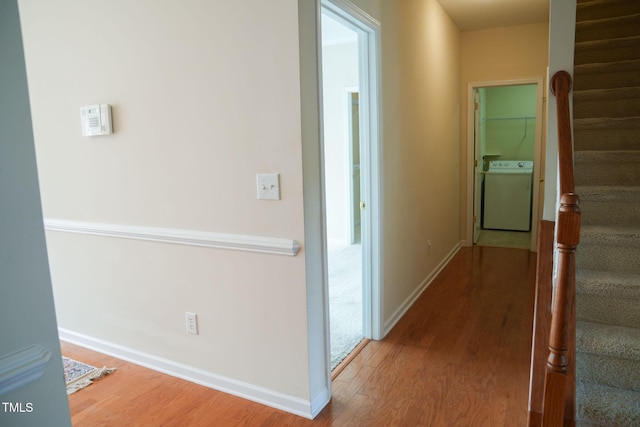 3423 Van Hessen Dr, Raleigh, NC 27614 - hallway featuring washer / dryer, wood finished floors, and stairs