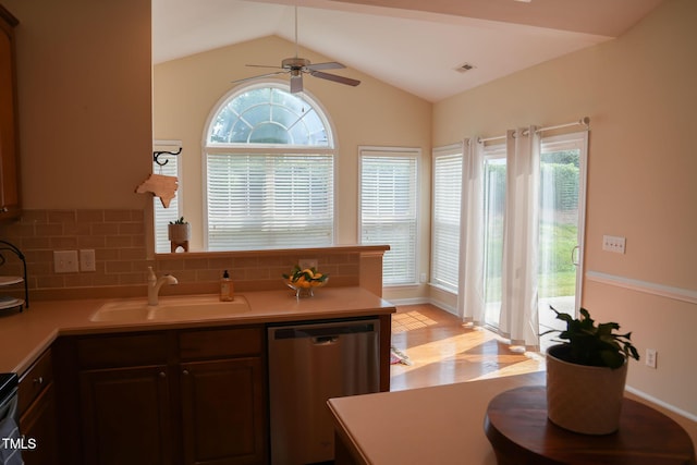 3423 Van Hessen Dr, Raleigh, NC 27614 - kitchen featuring dishwasher, light countertops, a ceiling fan, lofted ceiling, and light wood-style floors