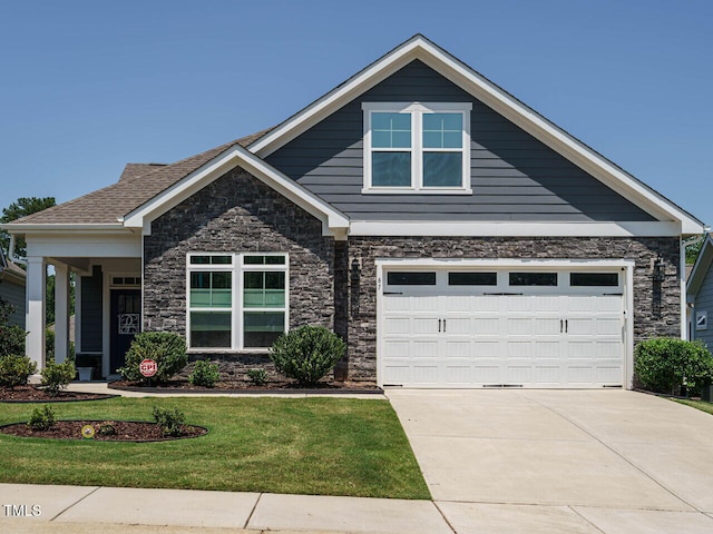 67 Blue Spruce Cir, Clayton, NC 27527 - craftsman-style house with stone siding, a front yard, concrete driveway, and a garage