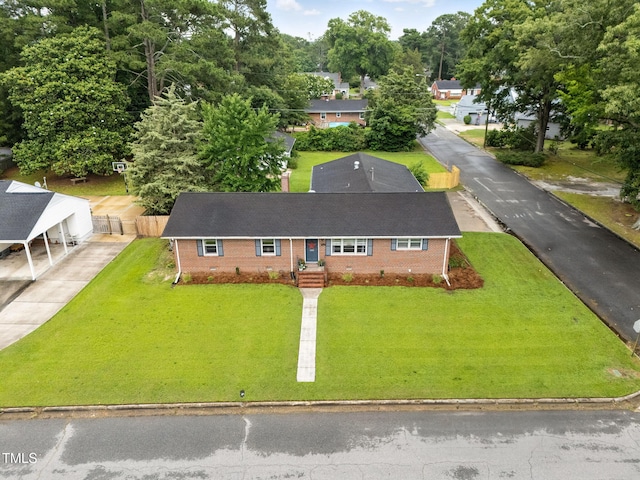 1015 S 1st St, Smithfield, NC 27577 - view of front of home with brick siding, driveway, and roof with shingles