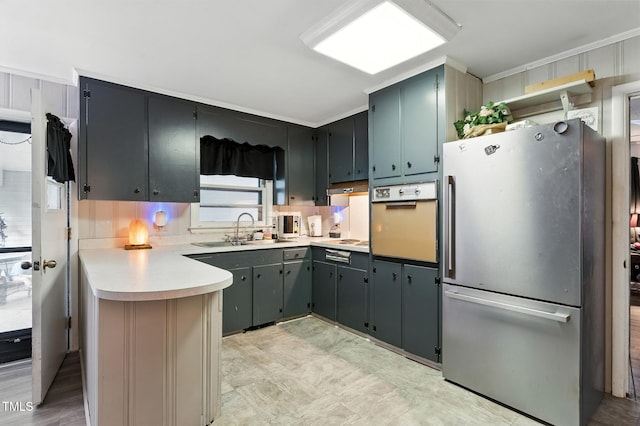 1015 S 1st St, Smithfield, NC 27577 - kitchen with freestanding refrigerator, oven, a peninsula, light countertops, and under cabinet range hood