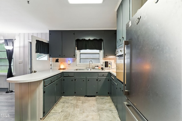 1015 S 1st St, Smithfield, NC 27577 - kitchen with freestanding refrigerator, a peninsula, light countertops, and gray cabinetry