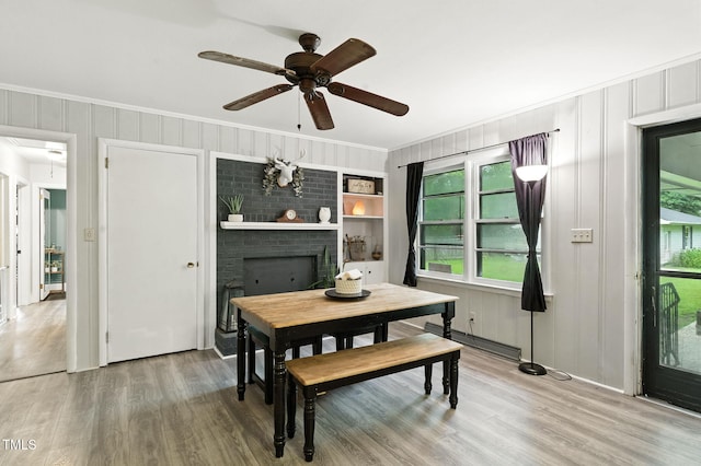 1015 S 1st St, Smithfield, NC 27577 - dining area featuring wood finished floors, a ceiling fan, plenty of natural light, ornamental molding, and a decorative wall