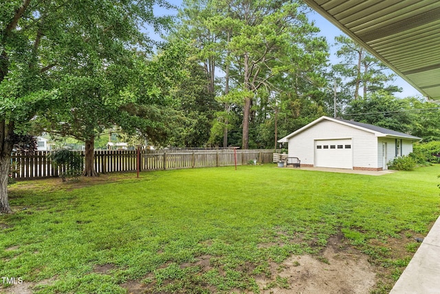 1015 S 1st St, Smithfield, NC 27577 - fenced backyard with a garage, an outdoor structure, and view of scattered trees
